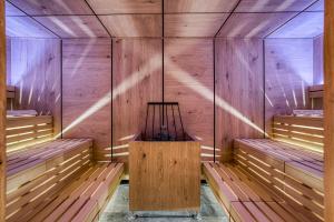 an empty sauna with wooden walls and benches at Hotel Alpenstolz - Culinary Hideaway Stubai in Mieders