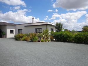 a white house with plants in front of it at Océane in Saint-Augustin