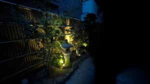 a fire hydrant with lights on a fence at night at Dream Stays SORA in Izumi-Sano
