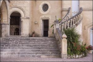 a building with stairs leading up to a door at CHATEAU DE LA RIVIERE in La Rivière