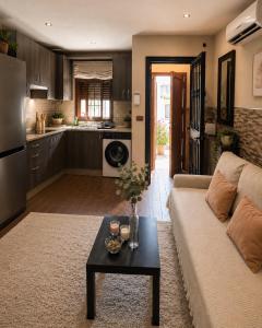 a living room with a couch and a table at Dúplex con Piscina y Terraza a 5 min de Sevilla in Camas