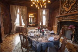 a dining room with a table and a fireplace at CHATEAU DE LA RIVIERE in La Rivière