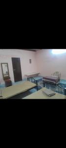 a room with two tables and a table and chairs at Sakshi Gopal in Vrindāvan