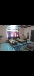 a room with benches and a table and a window at Sakshi Gopal in Vrindāvan