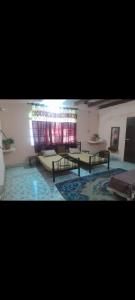 a room with benches and a table and a window at Sakshi Gopal in Vrindāvan