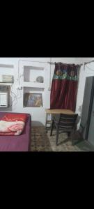 a living room with a couch and a table and a curtain at Sakshi Gopal in Vrindāvan