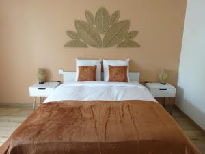 a bedroom with a large bed with two night stands at Les Précieuses in Réaumur