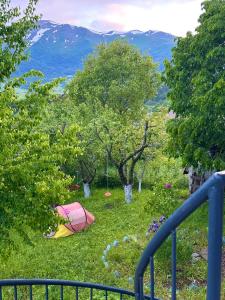 a view of a field of grass with trees at Cozy Dez Guest House with Dreamy Mountain Views in Margahovit