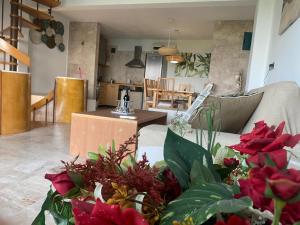 a living room with red flowers on a couch at Afremar Estate in Nea Fokea