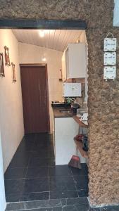 a small kitchen with a counter and a microwave at L&S casa da lagoa in Búzios +22 photos