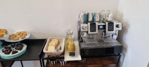 a coffee machine sitting on a shelf with food at Eva Luxury Saint Remy in Cagliari