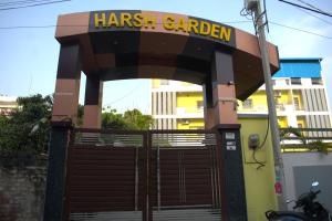 a entrance to a car garage with a sign on it at Hotel Harsh Garden in Varanasi