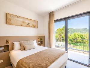 a bedroom with a bed and a large window at Villa Déoni in Zonza +35 photos