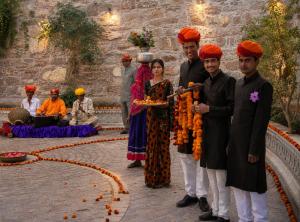a group of people posing for a picture with carrots at Castle Bijaipur - A Luxury Heritage Resort, Chittorgarh in Bijaipur