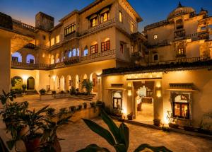 a large building with a courtyard at night at Castle Bijaipur - A Luxury Heritage Resort, Chittorgarh in Bijaipur