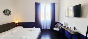 a hotel room with a bed and a window at Eva Luxury Saint Remy in Cagliari
