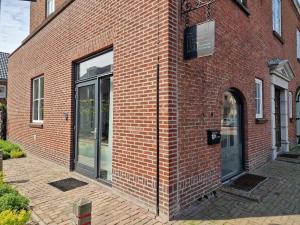 a brick building with a door on the side of it at De Oude Brandweerkazerne 2 tot 4 persoons 2 kamer appartement in Kaatsheuvel