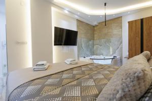 a bedroom with a large bed and a sink at Aqua Studios with Spa & Free Parking in Jagodina +15 photos