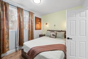 a bedroom with a bed and a large window at Jade Bear Retreat in Big Bear City