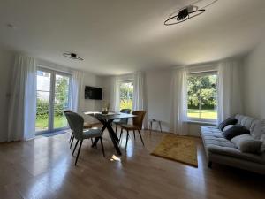 a living room with a couch and a table and chairs at Landhaus Heck in Pfronten