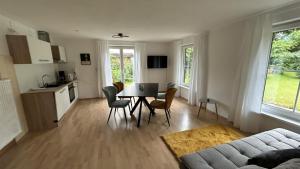 a living room with a table and chairs and a kitchen at Landhaus Heck in Pfronten