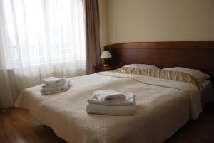 a hotel room with a bed with towels on it at Polonia in Kudowa-Zdrój +46 photos