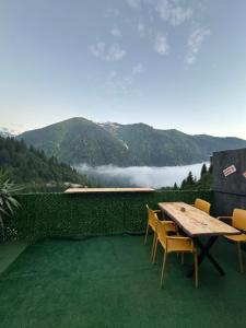 a table and chairs with a view of a mountain at Peak ayder bungalow in Ayder Yaylasi