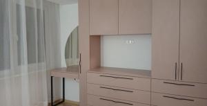 a white cabinet with a desk in a room at Baltas beržas in Anykščiai