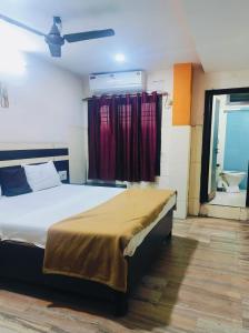a bedroom with a bed and a window at M R Hotels in Visakhapatnam