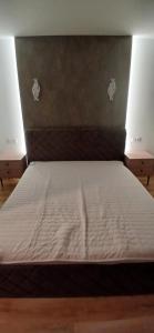 a bed in a room with at Baltas beržas in Anykščiai