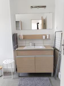 a bathroom with a sink and a mirror at Dömper Döme Apartman 1E in Balatonlelle +10 photos