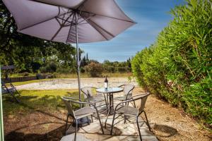 a table with chairs and an umbrella on a patio at Harmony House Corfu in Kynopiástai +15 photos