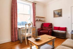 a living room with a table and a chair at Spacious Pretty home in Old Totterdown in Bristol