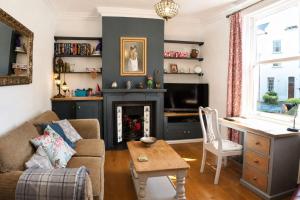 a living room with a couch and a fireplace at Spacious Pretty home in Old Totterdown in Bristol
