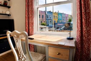 a desk with a chair in front of a window at Spacious Pretty home in Old Totterdown in Bristol