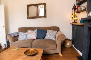a living room with a couch and a table at Spacious Pretty home in Old Totterdown in Bristol