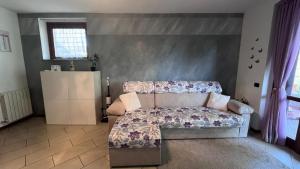 a living room with a couch and a table at Lilac Cozy Retreat in Angera