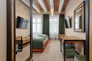 a hotel room with a bed and a mirror at Oysters & Bubbles Gastro Hotel. Rynok square in Lviv