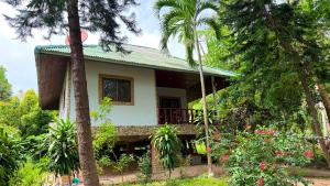 a house in the middle of a forest with palm trees at Zen Trinity House in Ko Phangan