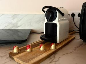 a cutting board with a toaster and four red candles at Gîte cottage & spa in Joze