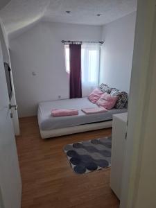 a small bedroom with a bed and a window at Stan na dan -Bratunac- in Bratunac