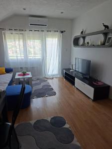 a living room with a couch and a tv at Stan na dan -Bratunac- in Bratunac