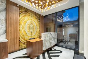 a lobby with a large painting on the wall at Carlton Hotel Tashkent in Tashkent