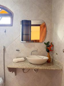 a bathroom with a sink and a mirror on the wall at Casa Magna in Itacaré +62 photos