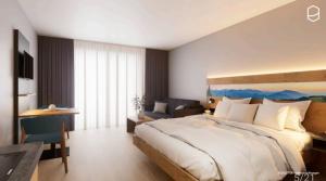 a large bedroom with a large bed and a desk at Gästehaus Attenhauser in Unterammergau