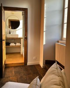 a bathroom with a sink and a mirror at Le Château de Saint-Angel, Le Manoir du Rigouneix, 5 minutes A89, nature, calme, sauna, CLIMATISATION in Saint-Angel +37 photos