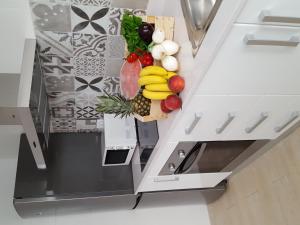 a bunch of fruits and vegetables on a kitchen counter at Mandala apARTments, confort y encanto a pie playa in Calafell