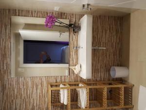 a bathroom with a mirror and a person taking a picture at Mandala apARTments, confort y encanto a pie playa in Calafell