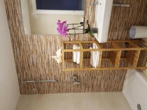 a bathroom with a shower with towels and flowers at Mandala apARTments, confort y encanto a pie playa in Calafell +42 photos