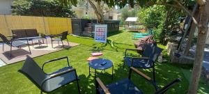 a yard with chairs and a table and a grill at Sky Apartments Petrovac in Petrovac na Moru